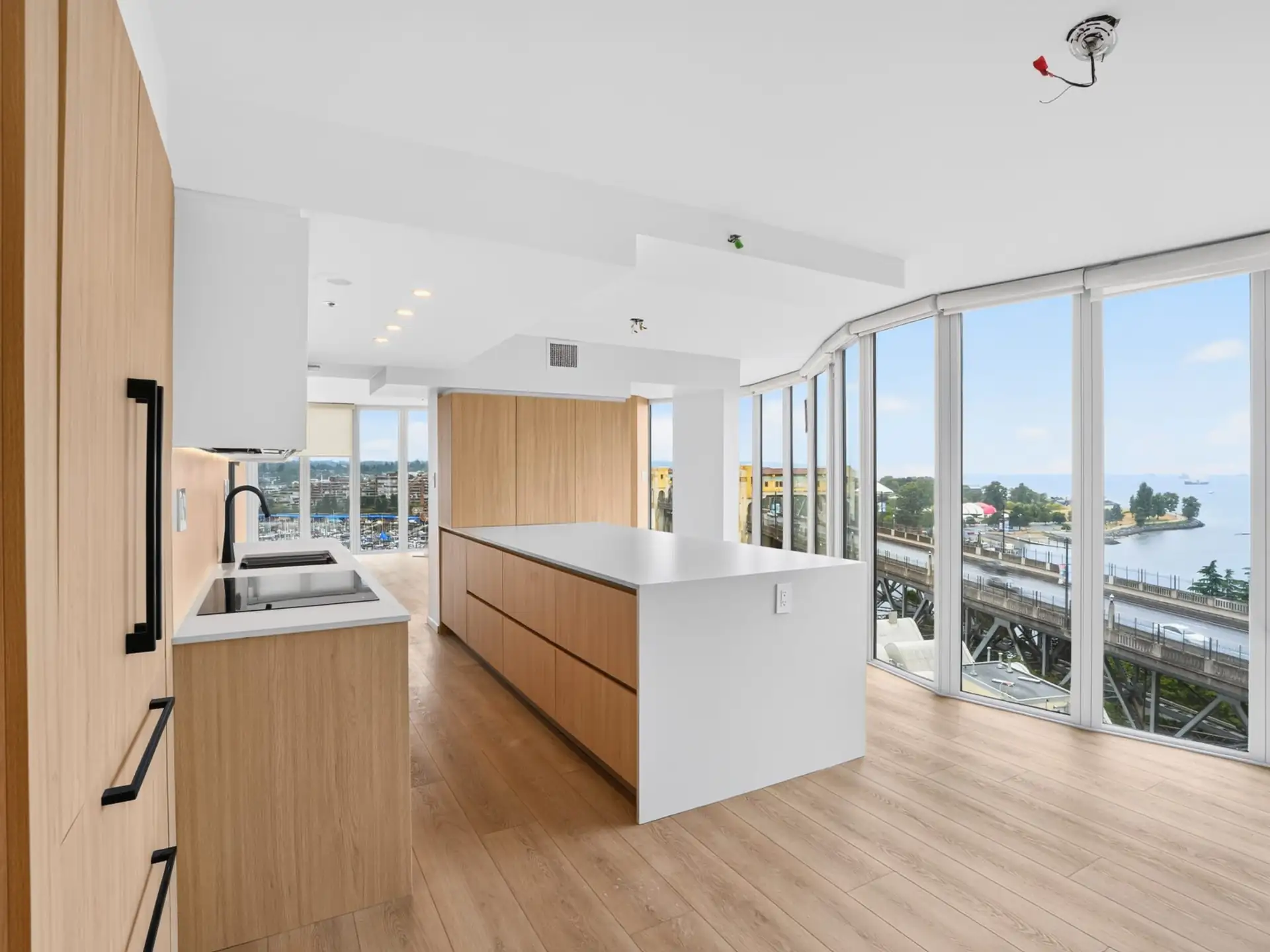 Renovated Yaletown kitchen with light wood cabinetry and a long island