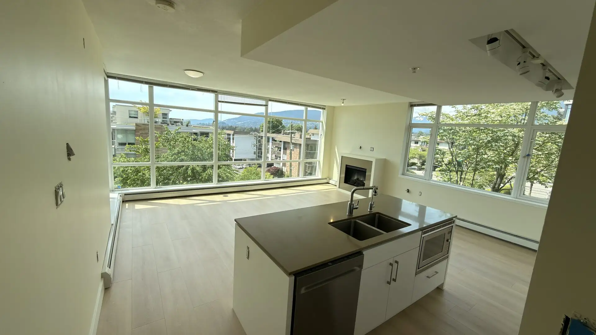 Renovated Lonsdale kitchen with an island and new flooring in North Vancouver