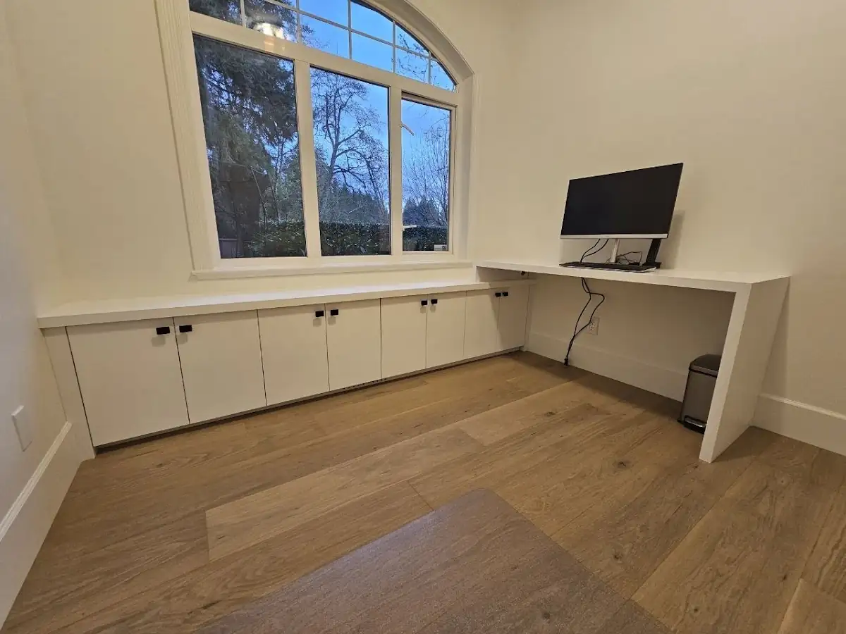 West Vancouver home office with built-in cabinets under an arched window