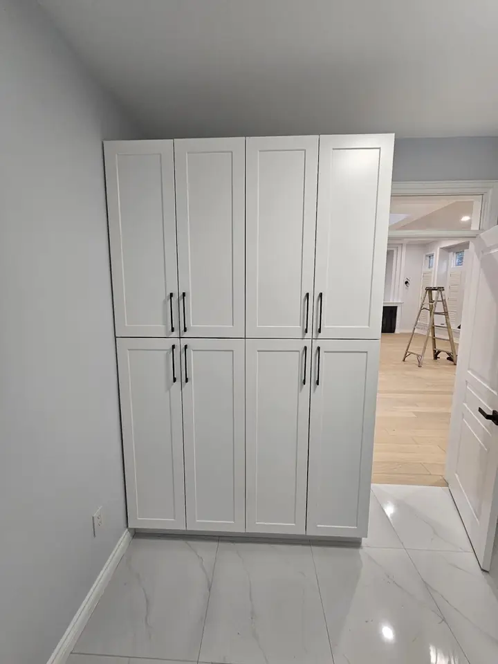 Floor-to-ceiling white storage cabinets in a Capilano home