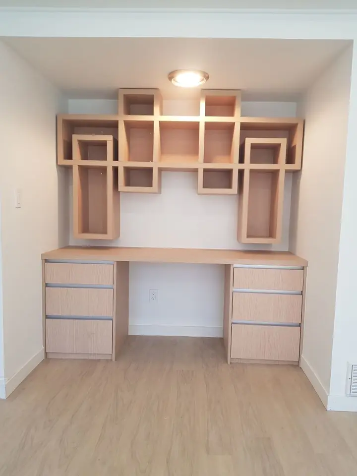 Built-in desk with drawers and open box shelving in a Delbrook home