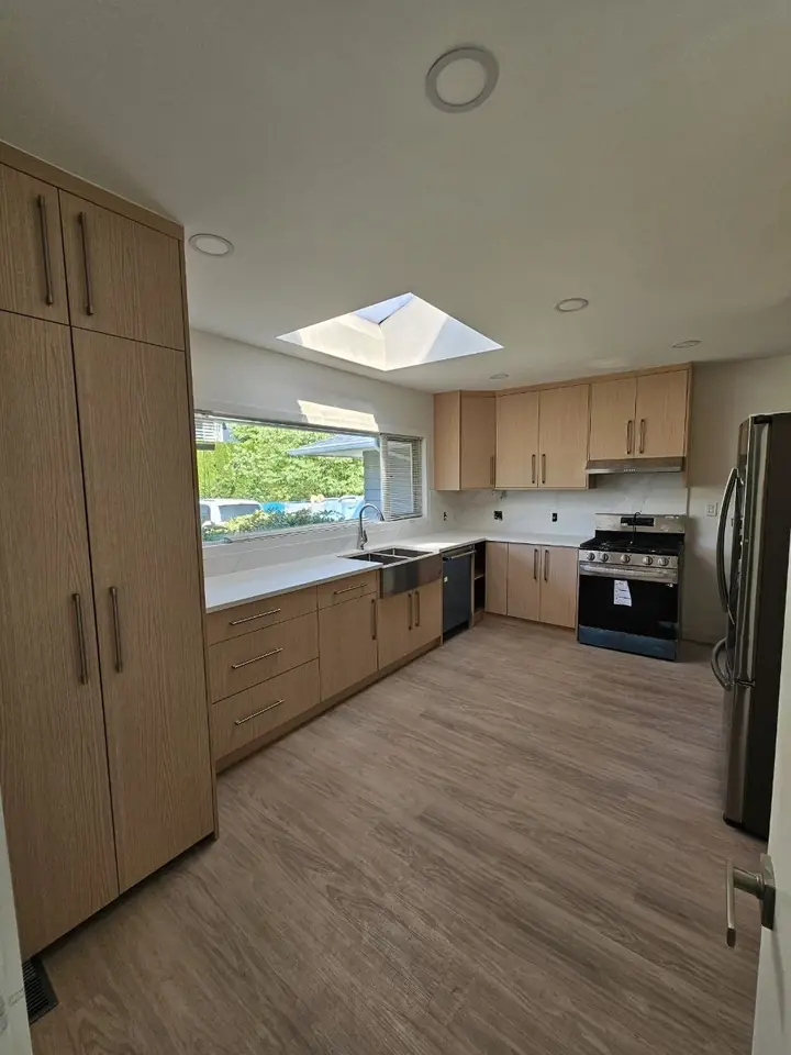 Custom wood kitchen cabinets running the length of the Delbrook kitchen