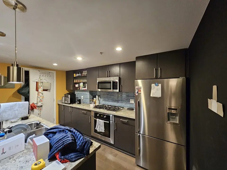 Downtown Vancouver kitchen before renovation, with dark cabinets