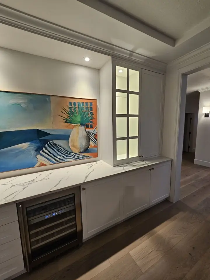 Built-in buffet with drawers, a wine fridge, lit glass display cabinets and an art niche, Dundarave