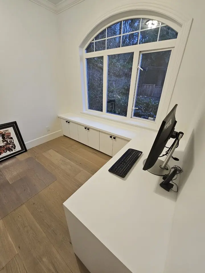 Built-in desk and storage cabinets in the Dundarave home office