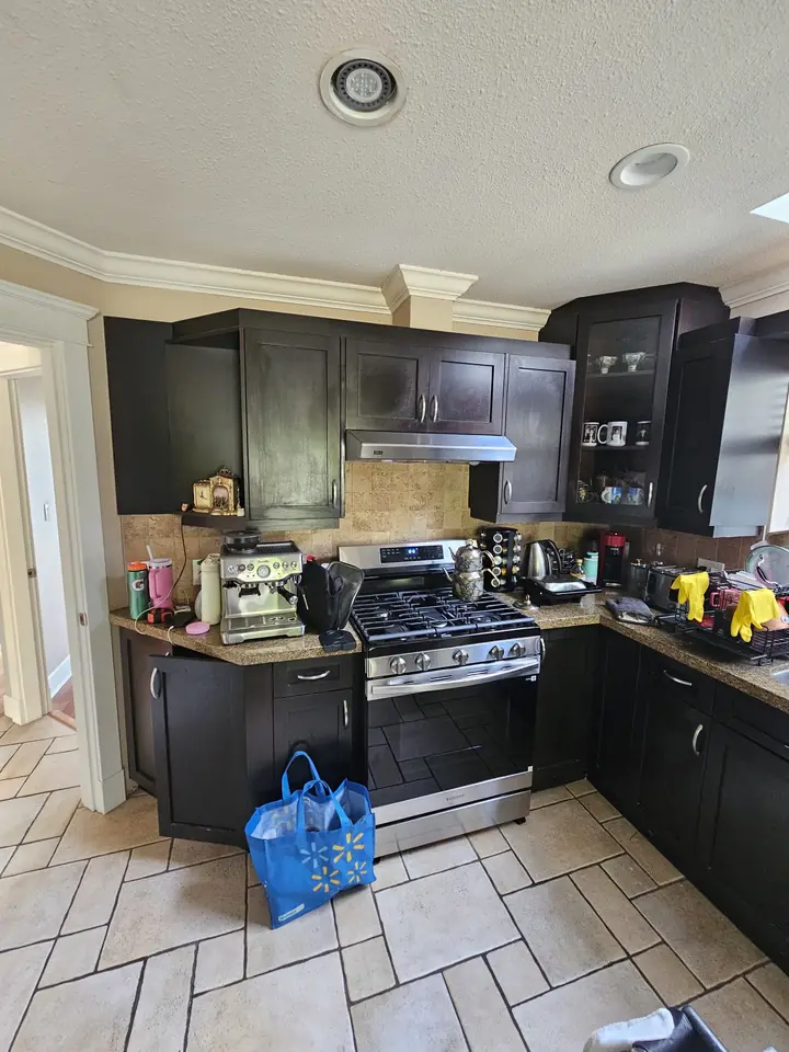 North Vancouver kitchen before the remodel, with dark cabinets and a tile floor