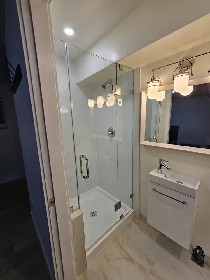Renovated bathroom with a glass shower and wall-hung vanity, UBC Vancouver