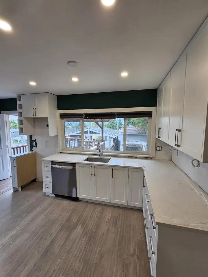 Vancouver 40th St kitchen renovation with white cabinets and a window over the sink