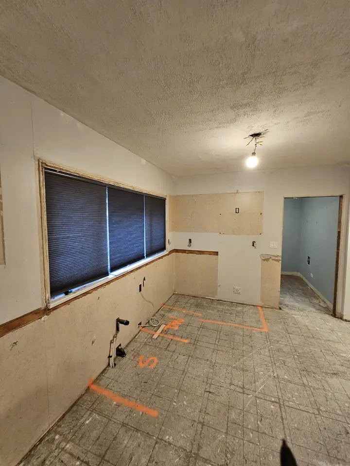 The 40th St kitchen before renovation, stripped back to the walls