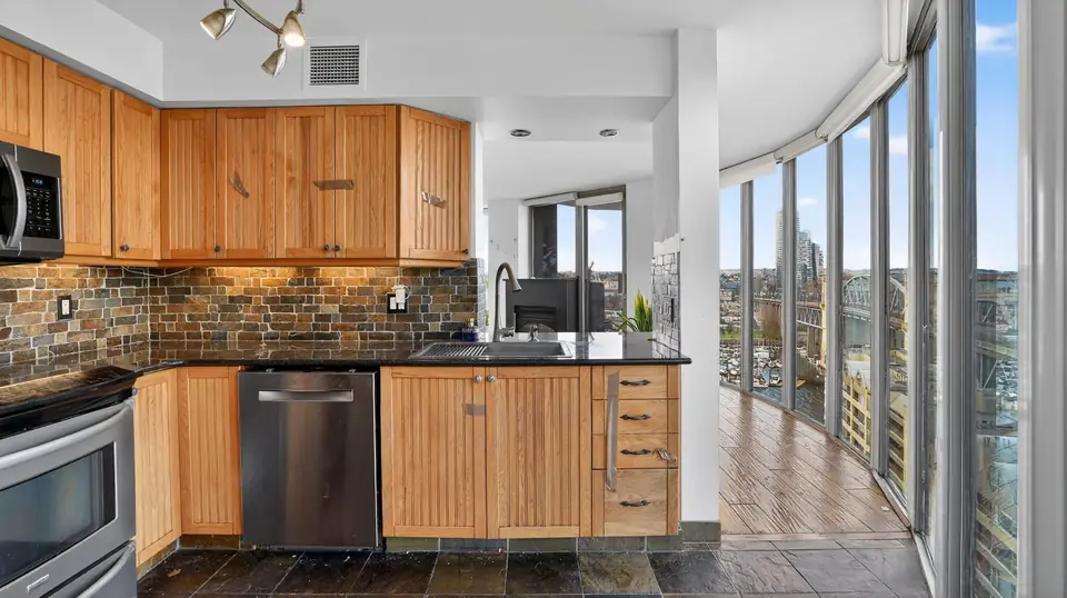 Yaletown kitchen before the remodel, with older wood cabinets and a slate tile backsplash